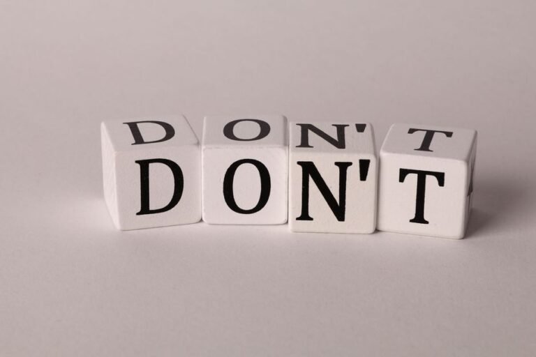 Text cubes spelling 'DON'T' on a clean white background, ideal for concepts of caution or prohibition.