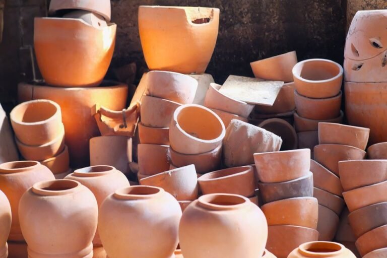 Stack of handcrafted terracotta pots displayed in a pottery workshop in West Java, Indonesia, showcasing artisanal craftsmanship.