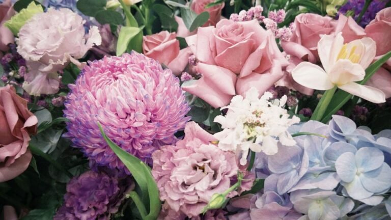 Vibrant bouquet of roses, tulips, and hydrangeas in pastel colors.