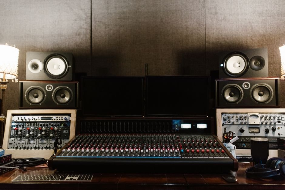 High-quality recording studio setup with sound mixer and speakers, ideal for music production.