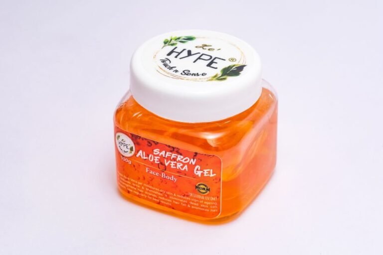 Close-up of a saffron aloe vera gel in a clear plastic container, ideal for skin care use.