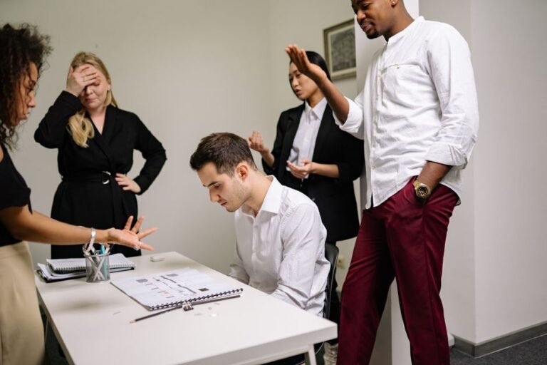 Business professionals engaged in a tense discussion at the office, highlighting workplace conflict.