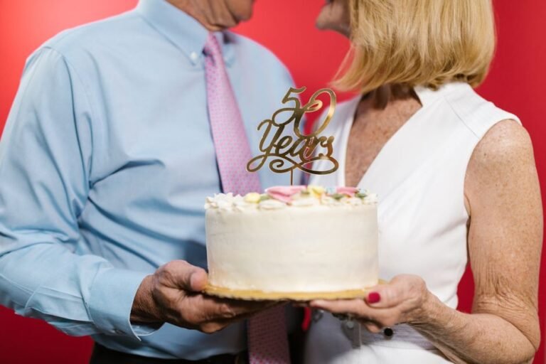 A couple celebrating their 50th anniversary with a decorative cake, symbolizing a lasting bond.