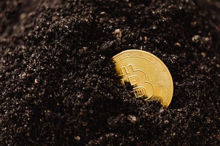 Golden Bitcoin partially buried in dark soil, symbolizing digital currency growth.